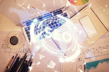 Poster - Double exposure of SEO drawing over study table background with computer. Concept of search. Top view.
