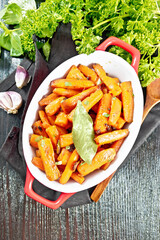 Wall Mural - Carrots fried in pan on black board top