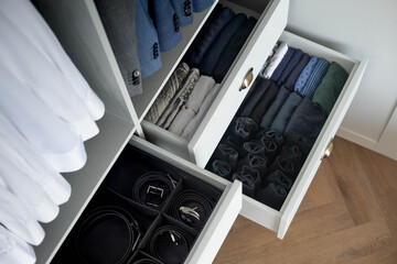 Wall Mural - Man cupboard clothes storage organization neatly folded belt underwear shirt and socks