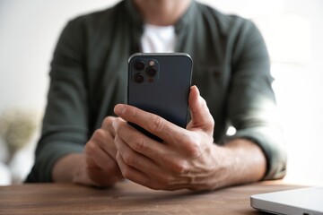 Close up of male hands with mobile. Man pointing on smartphone screen, chatting in social networks