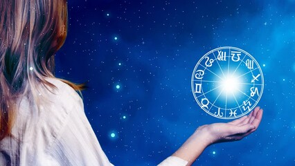 Wall Mural - young blonde woman keeping in hand a zodiac circle with symbols of all astrology signs over blue background with stars 