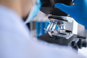 Wall Mural - scientist analyzing microscope slide at laboratory. young woman technician is examining a histologic