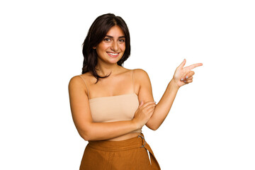 Wall Mural - Young Indian woman isolated on green chroma background smiling cheerfully pointing with forefinger away.