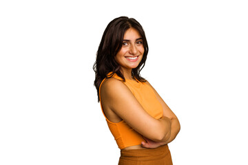 Young Indian woman isolated on green chroma background who feels confident, crossing arms with determination.