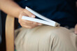 © patpitchaya - Closeup woman rest the book on her lap and bookmark the pages with finger
