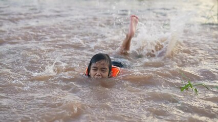 Wall Mural - Slow motion kids playing water flooding in rice field in countryside 