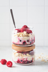 Wall Mural - Overnight oatmeal with raspberries, currants and tahini in jar. Breakfast concept.