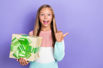 Sticker - Photo of overjoyed girl hand hold package arm direct show empty space offer service preparing event isolated on purple color background