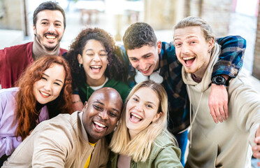 Wall Mural - Multicultural friends taking selfie at urban background - Happy milenial lifestyle concept with young multiracial people having fun day together