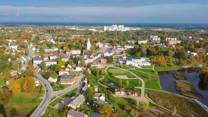 Wall Mural - Ruins of an Ancient Medieval Castle Dobele Latvia, Aerial Top View. Aerial Panorama of Dobele City, in the Foreground River With Fontains and Medieval Castle Ruins With Restored Castle Capella, Latvia