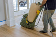 © ungvar - During of newly constructed house, floor sander is being used to grind down a wooden parquet floor