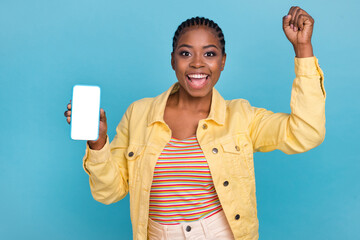 Portrait of attractive trendy cheerful girl using device copy space rejoicing isolated over bright blue color background