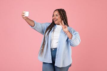 Wall Mural - African American Female Making Selfie On Smartphone Over Pink Background