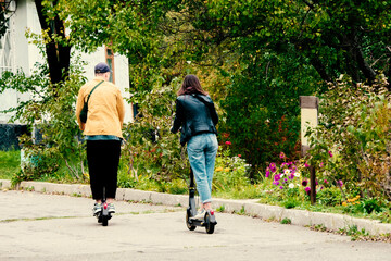 The couple rides electric scooters