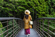 Woman walk on the wooden bridge in forest