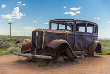 A Weathered And Rusting Studebaker Antique Car Sitting Along The Old Route 66 Highway.
