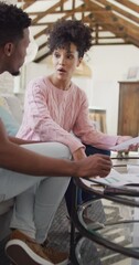 Canvas Print - Vertical video of african american couple talking and working