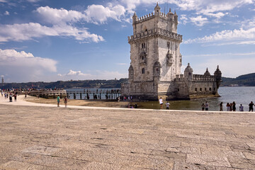 Tourists walking nearby Belem tower in Lisbon