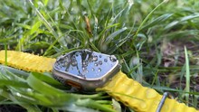 dew water drops in green grass on the new titanium Watch Ultra designed for extreme activities like endurance sports, elite athletes, trailblazing, adventure