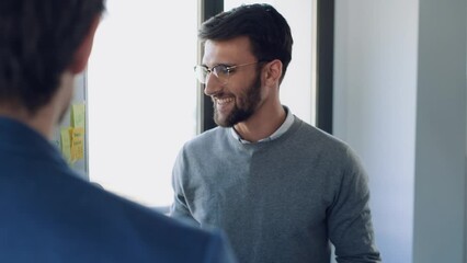 Wall Mural - Video of handsome businessman pointing at white blackboard and explain a project to her colleagues on coworking place.