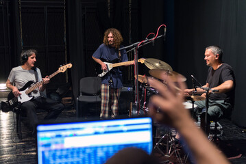 Wall Mural - Music band playing music and rehearsing in recording studio