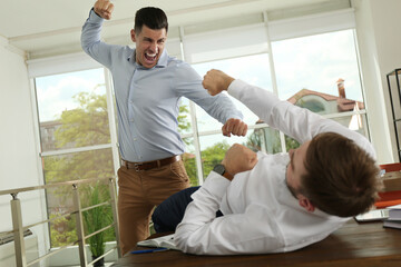 Wall Mural - Emotional colleagues fighting in office. Workplace conflict