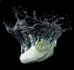 Wall Mural - head of lettuce with water splash isolated on black background,lettuce washing