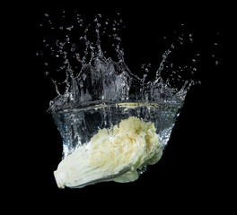 Wall Mural - head of lettuce with water splash isolated on black background,lettuce washing
