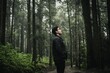 © Scopio - Side view of young man in leather jacket standing in the woods
