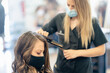 © Scopio - Woman with facemask getting her hair done at the beauty salon