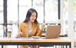 © David - Successful Business Asian woman looks surprised and excited at laptop screen, receive pleasant notification, watching on laptop computer, cellular internet, Excited happy asian woman.