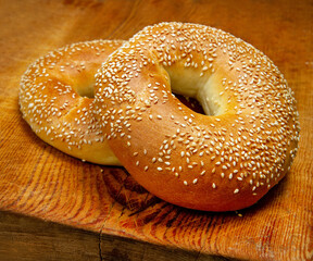 Bagels with sesame on the background of wood.