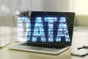 Poster - Creative Data word hologram on modern laptop background, big data and blockchain concept. Multiexposure
