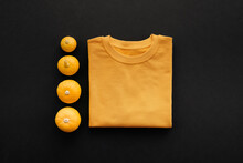 Directly From Above View Shot Of Contemporary Halloween Flat Lay Composition With Small Pumpkins And T-shirt On Dark Gray Surface