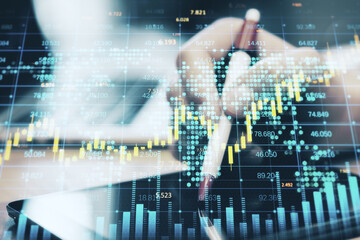 Poster - Close up of hand using digital tablet with pen and creative forex chart, candlestick graph, index and tech hologram on blurry background. Trade, stock, and finance concept. Double exposure.