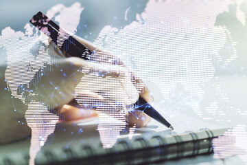 Poster - Abstract creative world map and woman hand writing in notebook on background, international trading concept. Multiexposure