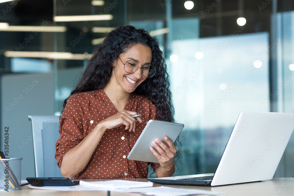 Young beautiful Latin American woman working inside modern office ...