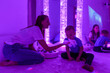 Special needs child in sensory stimulating room, snoezelen. Autistic child interacting with therapist during therapy session.