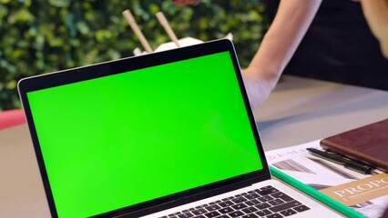 Poster - Laptop, green screen and woman at table planning, startup and talk in office or cafe. Computer, mockup and workers discuss data, study or information on the internet, in training or marketing closeup
