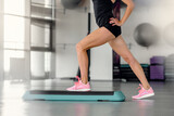 Fototapeta Kuchnia - Closeup of healthy slim sporty woman doing aerobics on step platform