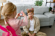 Daughter making shot of father with funny makeup