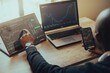 © Talent/Wirestock Creators - Young man holding a smartphone and laptop with online trading chart of crypto on the screen
