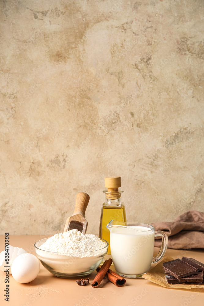 Ingredients for baking on table against beige background