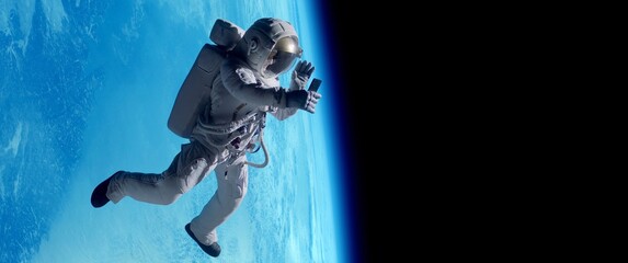female astronaut having a video call on her phone while performing space walk in open space, earth i