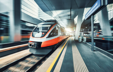 Wall Mural - high speed train in motion inside modern train station in vienna. fast red intercity passenger train