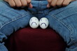 Young Asian man holding two chicken eggs with sad face on crotch groin area. Male infertility, testicular cancer and impotence concept. 