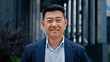© Yuliia - Close up front view in city outdoors Asian Korean man business boss leader company CEO smiling glad happy middle-aged businessman professional financial advisor executive leader manager male lawyer