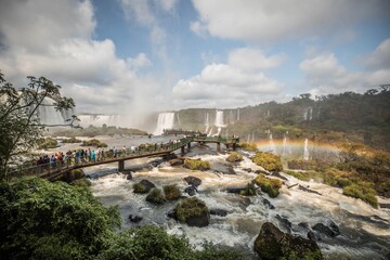 Canvas Print - Mesmerizing landscape of Iguacu Falls on a bright sunny day with a rainbow