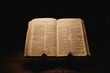 Closeup shot of a historic old Bible open on the Isaiah pages on display in a dark room