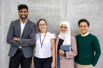 Poster - Shot of a small diverse group of businesspeople standing against a grey wall